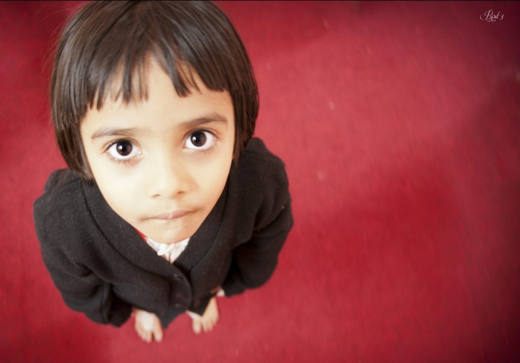 A child looking up at an adult